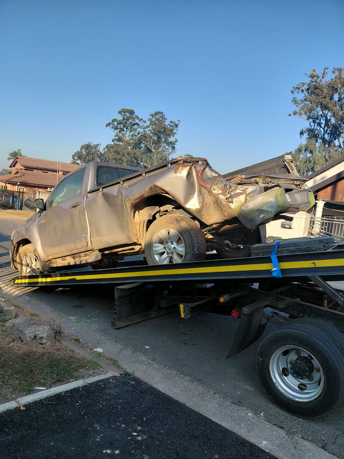 Van on a tow truck showing severe rear accident damage